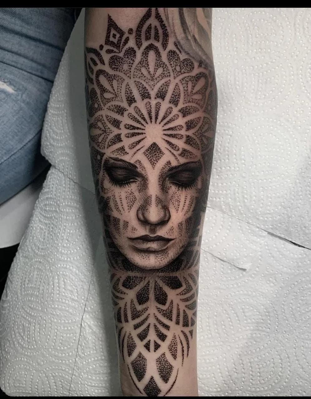 Mandala & Dotwork Tattoo mit Gesicht, symmetrischer Ornamentik und feinen Dotwork-Details – Blood Diamond Tattoo Ink.