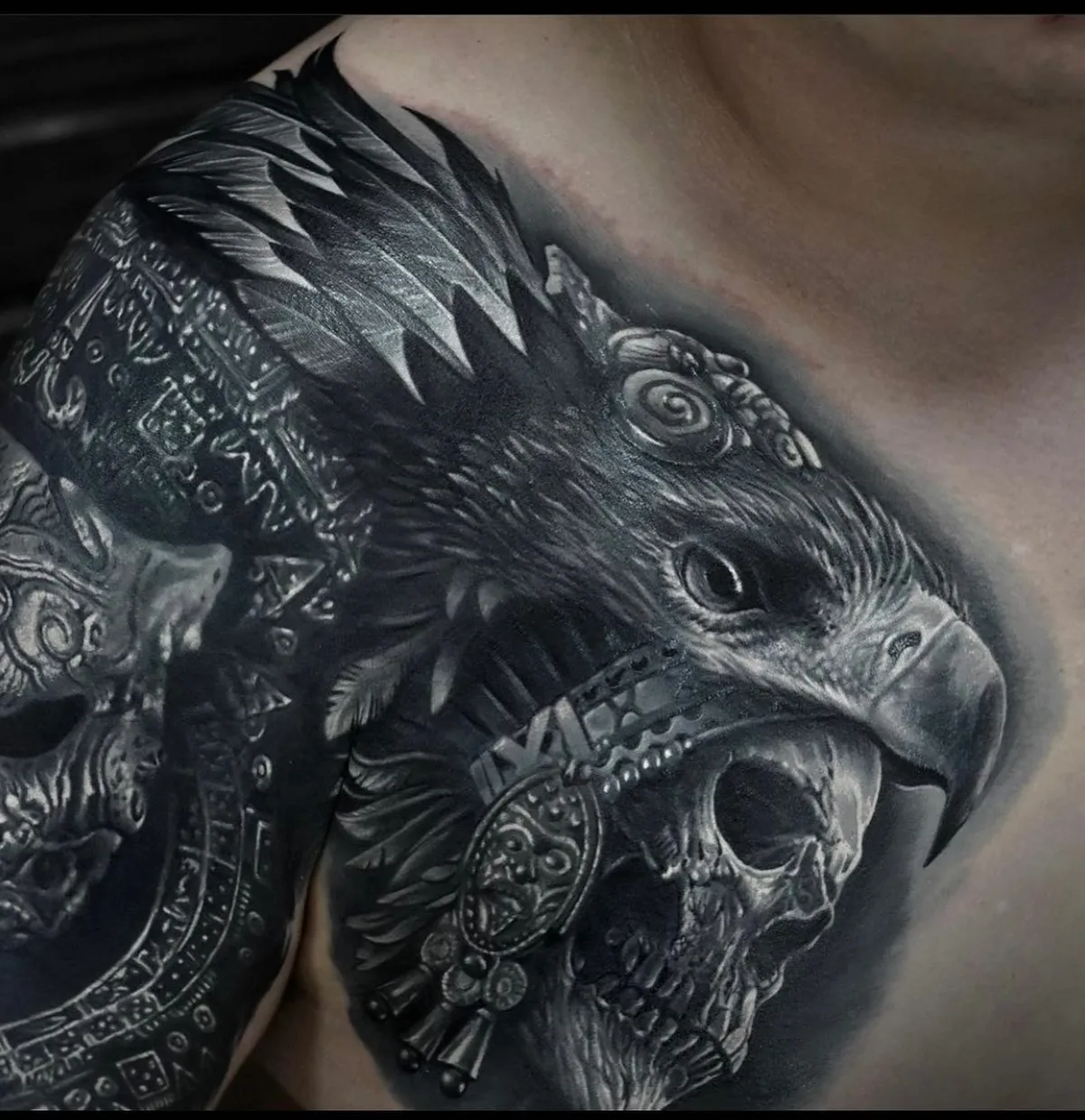 Realistisches Black-and-Grey-Tattoo mit Adlerkopf und Totenschädel am Schulter- und Brustbereich.